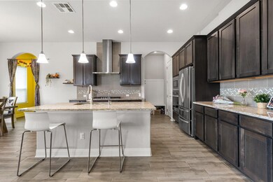 Kitchen featuring visible vents, arched walkways,