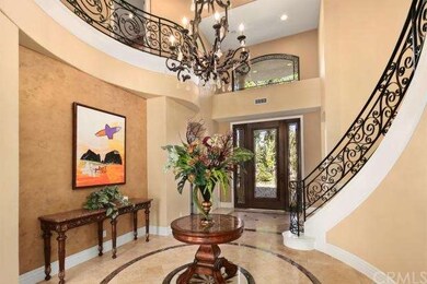 Elegant entry and foyer with curved staircase.