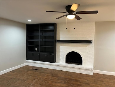 Unfurnished living room with dark wood finished floors, ceiling fan, a fireplace, and recessed lighting