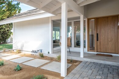Front door with private pathway to back patio and pool.