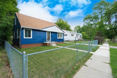 Bungalow with roof with shingles and a fenced front yard
