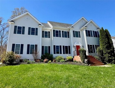 Colonial home featuring a front yard