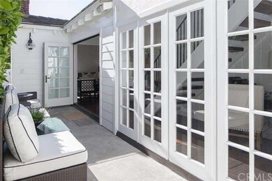 Bi-fold doors open up to a comfortable seating are