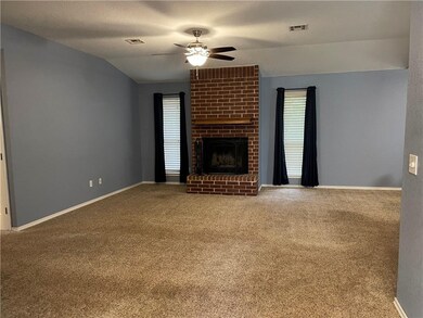 Living room is of good size with a wood burning fi