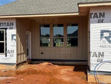 Entrance to property featuring a shingled roof and board and batten siding
