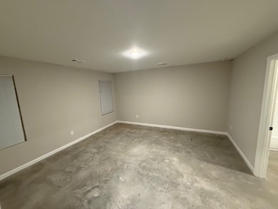 Empty room featuring concrete floors