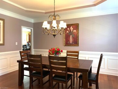 Elegant Dining Room with tray ceiling and plenty of natural light