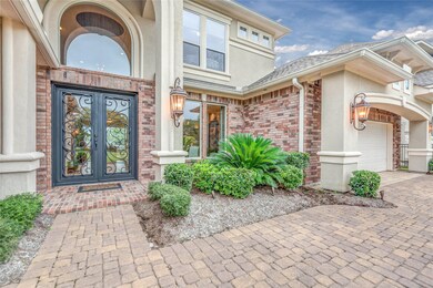 Heavy-duty double door entry w/ great accent landscaping and coach lighting.