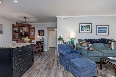 Living room featuring crown molding and hardwood /