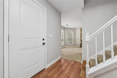 Entrance foyer featuring stairs, wood finished flo