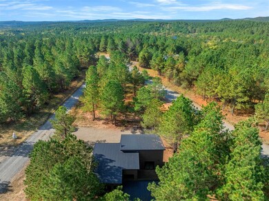 Aerial view of property's location featuring a heavily wooded area