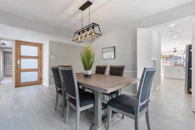 Dining room with recessed lighting and light wood-style flooring