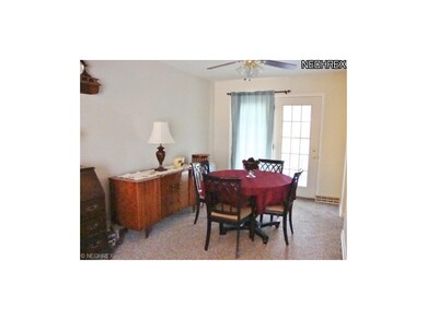 The dining room offers a ceiling fan and access to