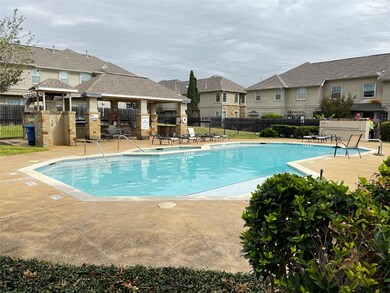 Community pool with a patio