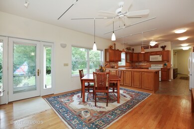 Large eating area with ceiling fan and hardwood fl