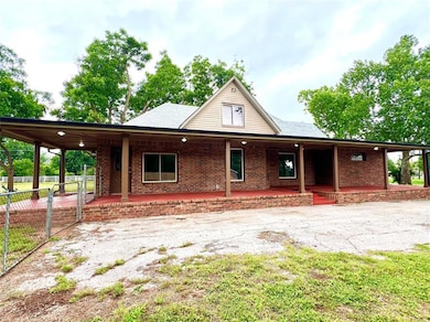 View of front facade featuring brick siding and a porch