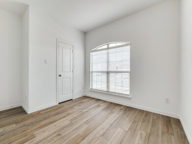 Front guest bedroom with large double window and walk-in closet.