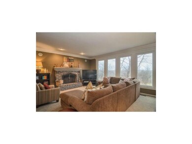 GREAT ROOM WITH WALL OF WINDOWS OVERLOOKING GOLF C