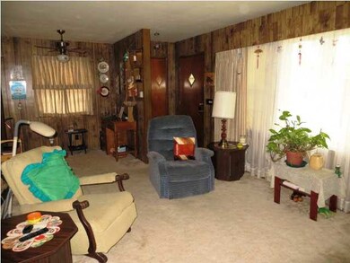 Living room with lighting above drapes