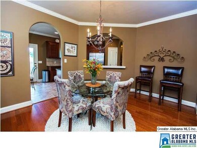 There is a charming dining room with an arched bre