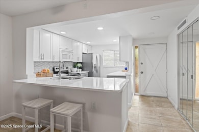 View of front door and kitchen