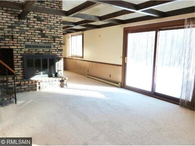 The floor-to-ceiling, brick fireplace in the Livin