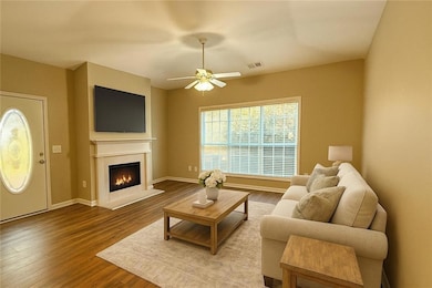 Living room with newer flooring, virtually staged to give you an idea