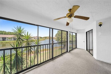 Carpeted sunroom with a expansive water view and s