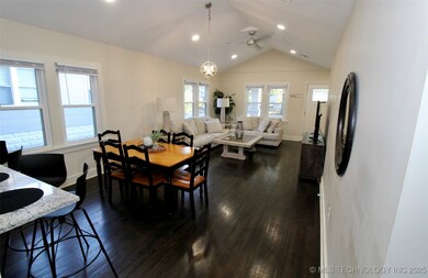 Dining space with a ceiling fan, vaulted ceiling,