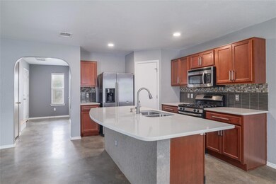 Kitchen with stainless steel appliances, a sink, 