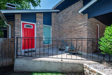 View of exterior entry featuring brick siding and