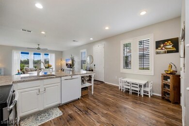 Kitchen with dishwasher, dark wood-style floors, r