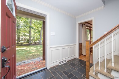 Inviting Foyer with slate floor, crown  molding and chair rail.
