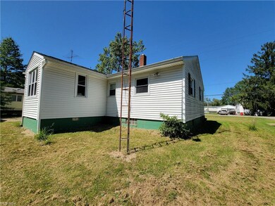 Rear view of house featuring a lawn