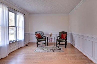 Formal Living Room with crown molding and wainscoting