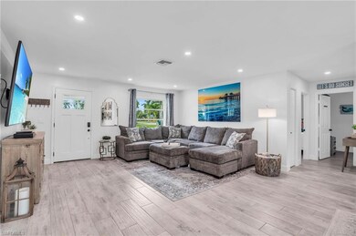 Living room with light hardwood / wood-style floor