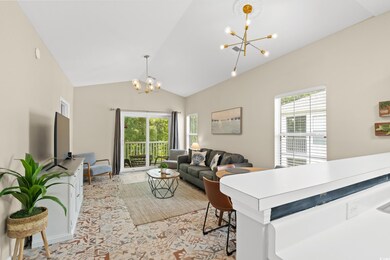 Living room with vaulted ceiling and an inviting c