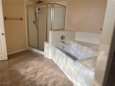 Bathroom featuring a shower stall, a whirlpool tub