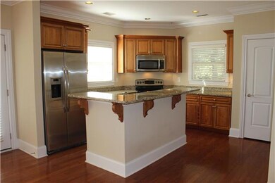 This Kitchen has it all - Granite Countertops, Stainless Steel Refrigerator, Dishwasher, Microwave, Stove, Garbage Disposal, Beautiful Moldings, Gorgeous Cabinetry, Pantry, Extra Counter space and a Bar on the Kitchen Island! 