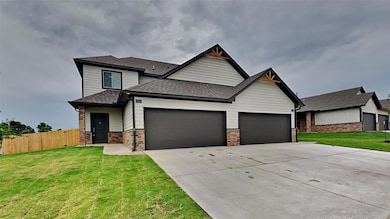 View of front of house with roof with shingles, a garage, driveway, and brick siding