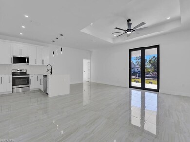 Unfurnished living room featuring a raised ceiling