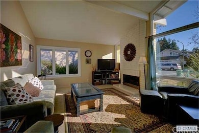Formal living room features brick fireplace and hu