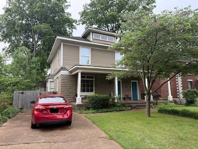 American foursquare style home featuring a porch a