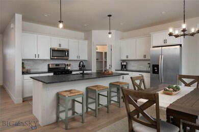 Open concept, granite countertops, gas stove.