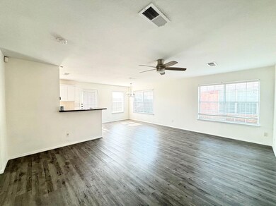 Unfurnished living room with ceiling fan and dark 