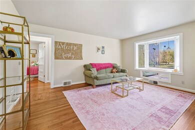 Living room with baseboards and light wood finished floors