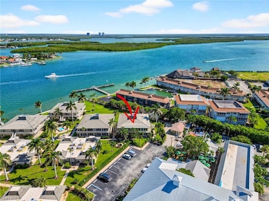 Aerial perspective of suburban area featuring a nearby body of water