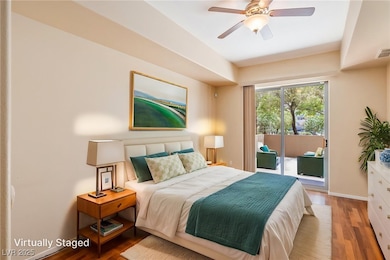 Primary Bedroom with ceiling fan and sliders creat