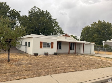 View of front of house featuring a porch, concrete driveway, stucco siding, and a garage