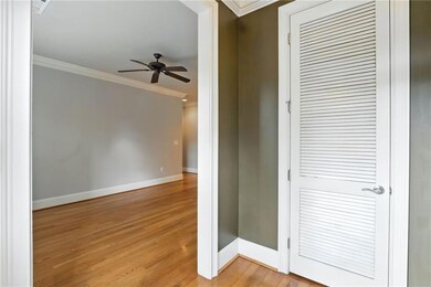 Hall with crown molding and light wood-style floors